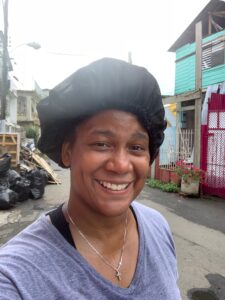 picture of Raenell Shirley doing volunteer work in Puerto Rico smiling sweating technology consulting